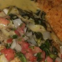 Pollo Con Espinacas · Grilled chicken breast smothered in our creamy cheese and spincach sauce. Served with pico d...