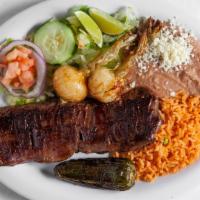 Carne Asada · skirt steak served with rice, beans and salad on the side