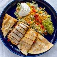 Quesadillas De Fajitas · Filled with your choice of beef, chicken or combination fajitas. Served with lettuce, guacam...