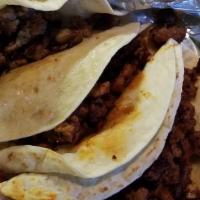 Tacos De Carne Asada · Three flour tortillas filled with your choice of delicious steak or chicken. Served with cha...