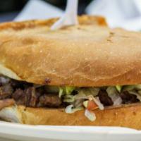 Steak Torta · Lettuce, tomato, sour cream, cheese, beans and hot sauce.
