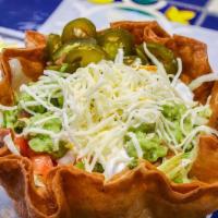 Steak Taco Salad · Flour tortilla shell , lettuce, tomato, sour cream, shredded cheese, nacho cheese, guacamole...