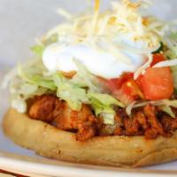 Chicken Sope · Lettuce, tomato, sour cream, cheese, beans and hot sauce.