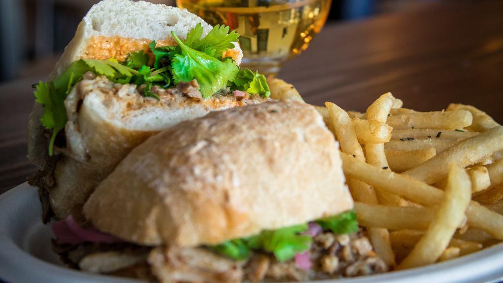 Johnny Hammer Pants · Sweet roasted pork, chipotle aioli, house pickled onion, cilantro on ciabatta with fries.