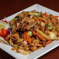 Pad Se’ Eaw · Flat noodles with eggs, cabbage, broccoli, carrots, mushrooms, baby corn and snow peas, lime...