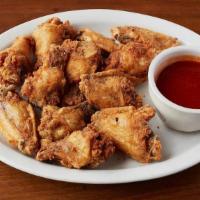 Traditional Wings · Fried crispy and served with Buffalo, Garlic Parmesan, Mango Habanero, or BBQ sauce. Tossed ...