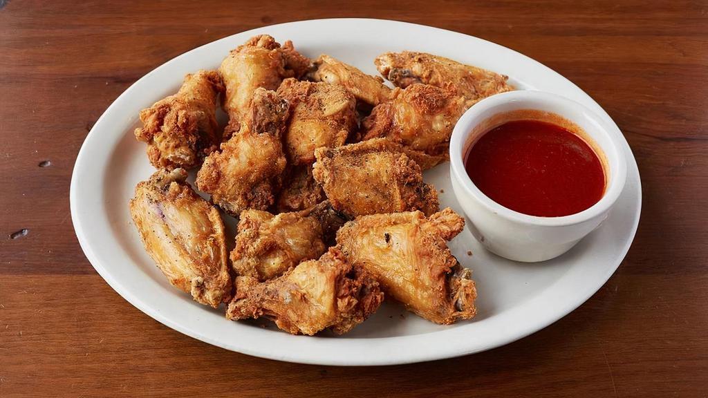 Traditional Wings · Fried crispy and served with Buffalo, Garlic Parmesan, Mango Habanero, or BBQ sauce. Tossed in sauce or on the side.