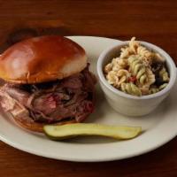 Pulled Pork Sandwich · Slow smoked, hand pulled pork served on a toasted brioche bun.