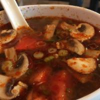 Tom Yum · Famous thai soup made with mushrooms, fresh tomatoes, lime juice, green onions and lemon gra...