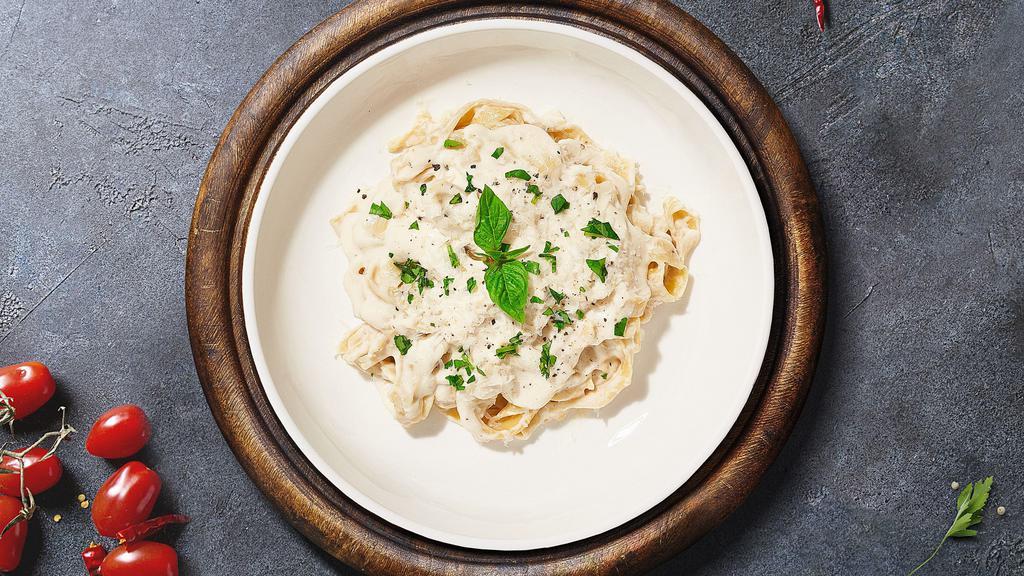 Alfredo Pasta · Fettuccine pasta cooked al dente tossed in creamy white sauce topped aged parmesan. Served with bread.