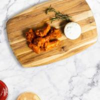 Fire Wings · Classic bone-in wings oven- baked, cooked to order perfectly crisp, and tossed with your cho...