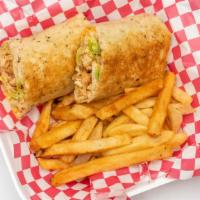 Chicken Shawarma · Marinated grilled chicken, garlic sauce, lettuce, tomato, pickles and onions on a grilled pi...