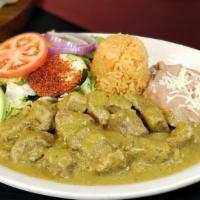 Guisado De Puerco · Tender chunks of pork stewed with homemade spicy green salsa. Served with Mexican rice, refr...