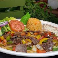 Bistec A La Mexicana · Succulent pieces of steak sautéed with bell peppers, Spanish onions, and tomatoes. Served wi...