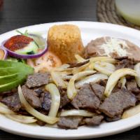 Cecina Encebollada · Succulent pieces of steak sautéed with grilled Spanish onion. Served with Mexican rice, refr...