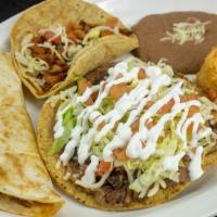 Combinacion 1 · One taco, one tostada, one quesadilla. Served with Mexican rice and refried beans.