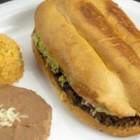 Torta Con Arroz Y Frijoles · Mexican sandwich with Mexican rice and refried beans.