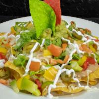 Veggie Deluxe Nachos · Crisp tortilla chips topped with sautéed bell peppers, onions, melted Chihuahua cheese, bean...