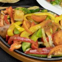 Veggie Deluxe Fajitas · A sizzling hot choice accompanied by caramelized Spanish onions, diced tomato, sautéed bell ...