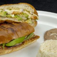 Avocado Torta · Mexican sandwich filled with fresh avocado slices, refried beans, cheese, lettuce, tomato sl...