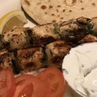Souvlaki Platter · Two marinated skewers (pork or chicken) served with onions, tomatoes, and homemade tzatziki ...
