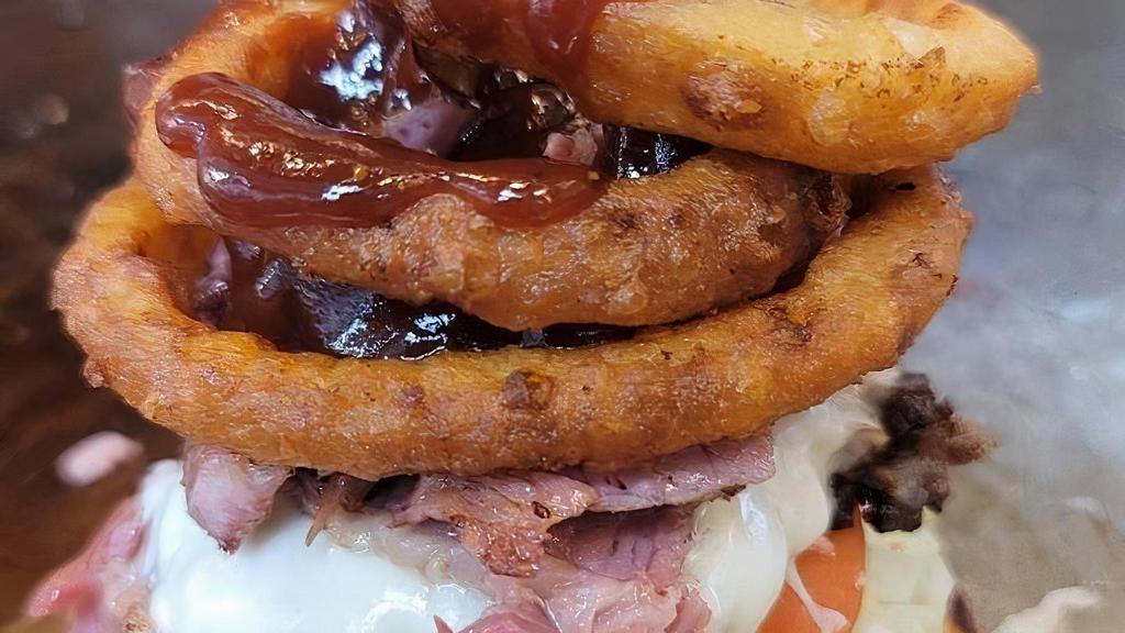 The Western Burger · Double cheeseburger, American cheese, topped with homemade corned beef, onion ring, BBQ souse, served on a grilled brioche bun.