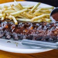 Bbq Baby Back Pork Ribs · Tender, slow roasted baby back ribs basted with our famous house BBQ sauce. Served with clai...