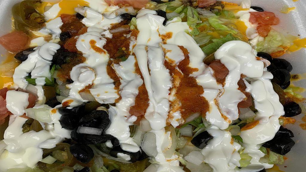 Supreme Nachos · Tomato, onion, black olive, jalapeño pepper, lettuce, sour cream, nachos cheese,  salsa. Ground Beef