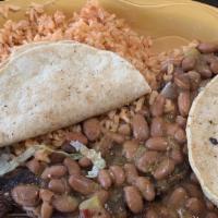 Loco'S Carne Asada · Tender skirt steak topped with our original frijoles charros. Served with two quesadillas, S...