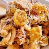 Calamari · Fried calmari, zucchini, peppadew and banana peppers, roasted garlic aioli, and lemon.