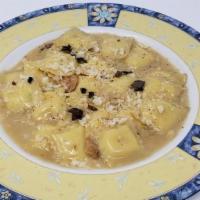 Ravioli Quadratini · Ricotta, parmesan cream, and shaved truffle.