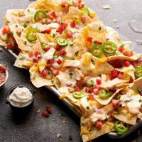 Legendary Loaded Nachos · Grilled chicken layered with shredded cheddar cheese, white queso, jalapeños and pico de gal...