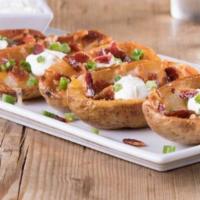 Potato Skins · Topped with cheddar-jack cheese, bacon and green onions. Served with a side of sour cream
.