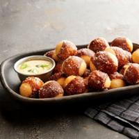 Pretzel Bites · Baked to perfection and tossed with Kosher salt. Served with a side of queso