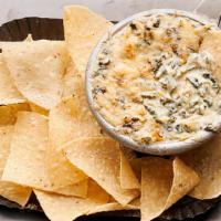 Spinach-Artichoke Dip · Creamy white American and Asiago cheeses, spinach and roasted artichokes, topped with shredd...