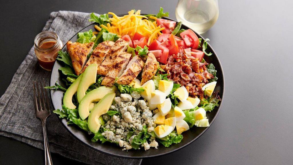 Chicken Cobb Salad · Grilled chicken, applewood bacon, mixed greens, cheddar cheese, bleu cheese crumbles, grape tomatoes, hard-boiled egg, sliced avocado and a side of balsamic vinaigrette