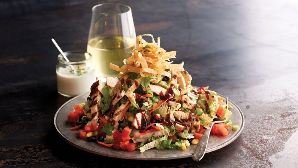 Bbq Chopped Salad · Grilled chicken, mixed greens, cheddar cheese, corn, black beans, carrots, tomatoes, green onions and corn tortilla strips. Tossed with chipotle-ranch dressing and sweet BBQ sauce.