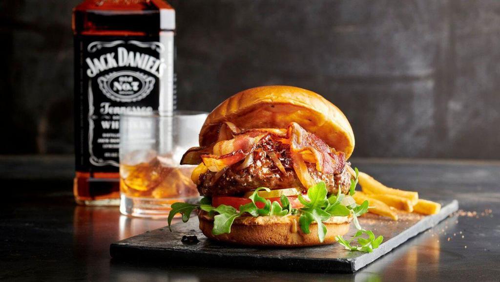 Bourbon Wagyu Burger · Premium 100% grass-fed Wagyu beef topped with applewood bacon, sweet bourbon glaze, caramelized onions, cheddar cheese, barbecue aioli, spring mix, tomato and pickles