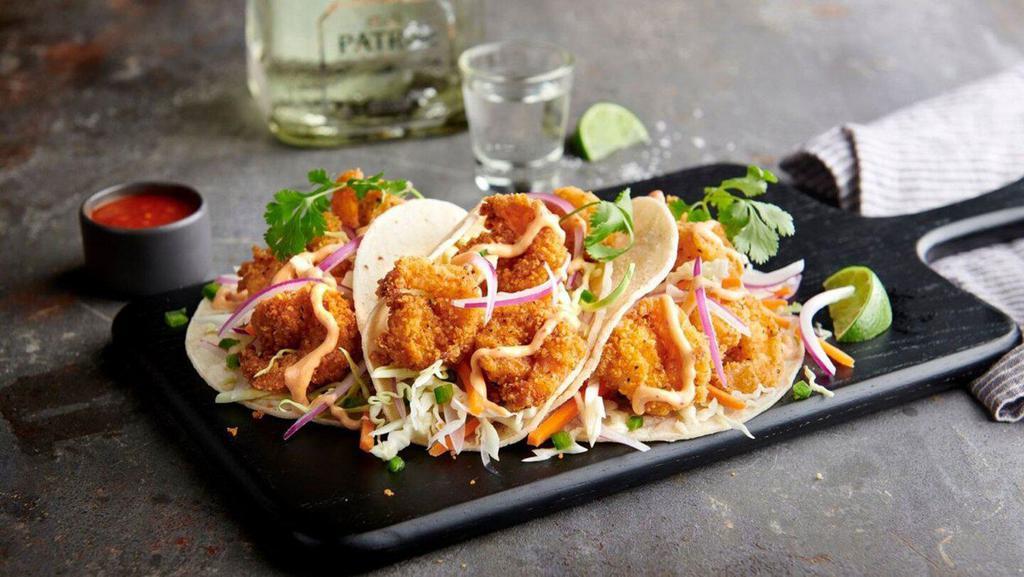 Crispy Shrimp Tacos · Fried shrimp topped with shredded cabbage mix, red onion, cilantro and Boom-Boom sauce. Served with a side of chips, salsa and Atomic sauce