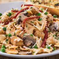 Vodka Chicken Pasta · Sautéed mushrooms and peas tossed in a spicy vodka cream sauce with farfalle pasta and parme...