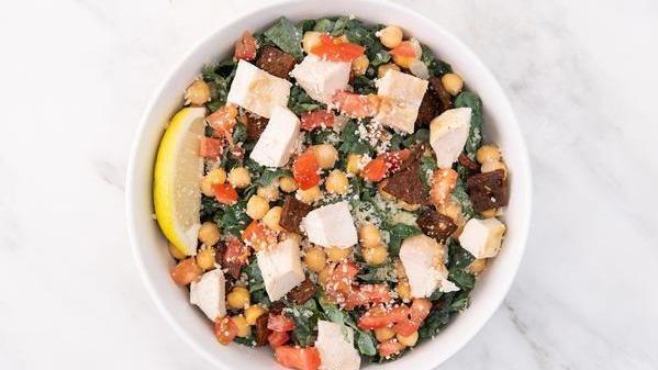 Kale Caesar Salad · Chopped fresh kale, chickpeas, diced tomatoes, grated parmesan cheese, vegan caesar dressing (served on the side).