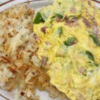 Western Omelette · Ham, green peppers, onion and cheese. Made with three eggs and served with hash browns or pa...