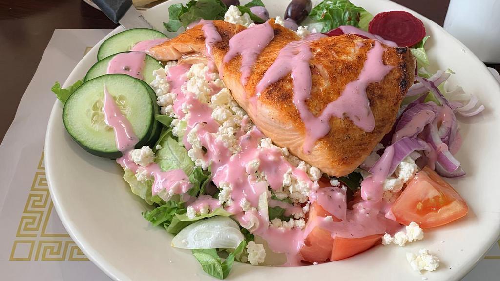 Greek Salad · Mixed greens topped with Feta cheese, olives, red onions, beets, tomato slices, cucumbers, pepperoncini and our famous homemade Greek dressing, served with pita bread.