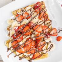 Strawberry Banana Nutella Crepe · Delicious crepes with Nutella folded in and topped with fresh strawberries and bananas.
