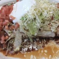 Enchiladas De Camaron · Three delicious shrimp enchiladas topped with cheese and served with rice and beans.