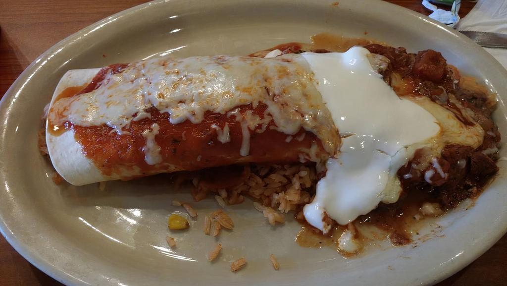 Hot & Spicy Burrito · Flour tortilla filled with chicken, beef, beans and rice, then covered with shredded beef, salsa ranchera, cheese and sour cream.