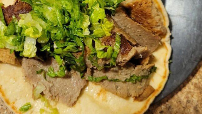 #13. Go Go Shawarma · Fresh sliced marinated lamb, onion, tomato, parsley, housemade tahini sauce.