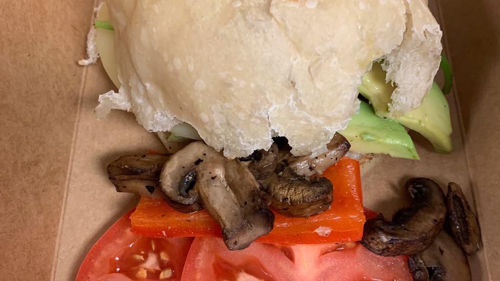 The Sarah · Bell peppers, sautéed mushrooms, havarti cheese, mustard, spinach, and avocado on ciabatta, sliced tomato on side.