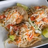 Shrimp Tacos · Deliciously marinated shrimp, cilantro lime slaw tomato and chihuahua cheese. Served on whit...