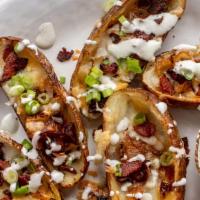Potato Skins · Baked with cheddar cheese and a side of sour cream